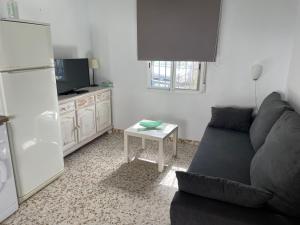 a living room with a couch and a table at Apartamento Antonia muy cerca de la playa in Bolonia