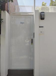 a white garage door with the number on it at Mi Limonero in Esperanza