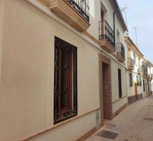 a building with a gate on the side of a street at Casa de la Escalera in Córdoba