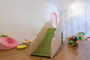 a childs play room with a slide in the middle of the room at Cest Mignon 包棟 溜滑梯 烤肉 麻將桌 夏日水池 in Dongshan