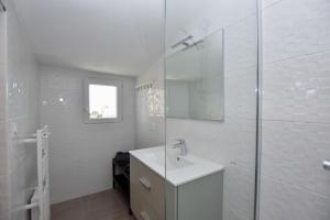 Un baño blanco con lavabo y ducha. en Les Deux Pins, en Notre-Dame-de-Monts 20 fotos más