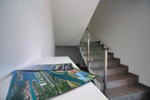 a magazine sitting on a table next to a staircase at Grande Rosa in Vrulje