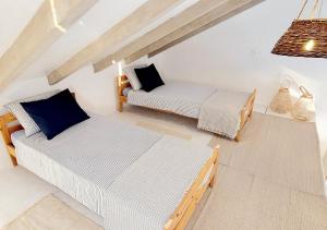 a living room with two beds and a couch at Seaside cottage 'Little white port' in Lučica