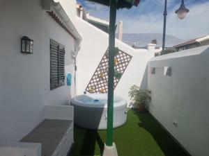 a bathroom with a bath tub on the grass at CHALET CON JACUZZI CLIMATIZADO, BARBACOA Y CERCA DE LA PLAYA in Abades