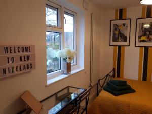 a room with a bed and a glass table at Kew Gardens - Private Double Room Richmond London - Homestay in Kew Gardens