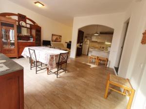 a kitchen and dining room with a table and chairs at La Terrazza Sul Blu in Corniglia