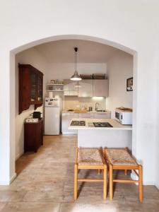 a kitchen with a table and two chairs in it at La Terrazza Sul Blu in Corniglia
