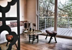 a room with a table and chairs and a large window at Kinzigloft mit Blick auf den Fluss in Gelnhausen