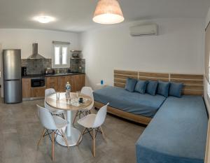 a bedroom with a bed and a table and chairs at Nissea Apartments in Naxos Chora