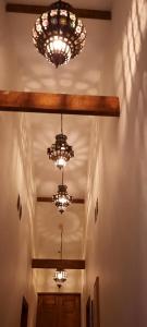 un corridoio con tre lampadari pendenti appesi a un soffitto di LA CASA MORISCA ad Alicante