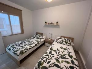 a bedroom with two beds and a window at Fuengirola Center in Fuengirola