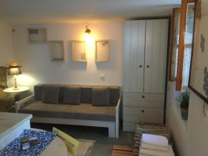 a living room with a couch and a cabinet at Traditional House Ekaterini Alonissos in Alonnisos