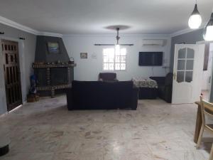 a living room with a couch and a tv at Casa Selene in El Puerto de Santa María