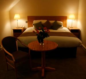 A bed or beds in a room at Deebert House Hotel