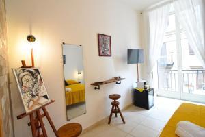a living room with a mirror and a bed at Napoli Cityscape in Naples
