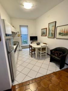 a kitchen and dining room with a table and a kitchen at Piazza Italia Charming Sea Apartments in Chioggia +26 photos