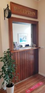 a reception desk with a clock on top of it at Hotel Seeburg in Sankt Peter-Ording