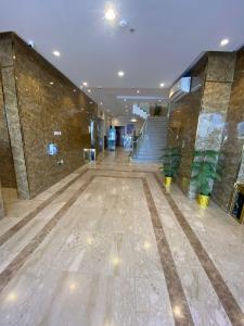 eine große Lobby mit einer Treppe und einem Gebäude in der Unterkunft ديار الأحبة للوحدات السكنية المفروشة in Sakaka