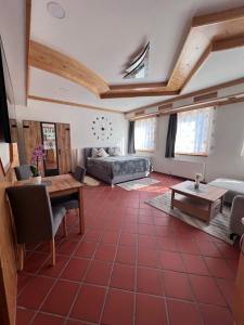 a living room with a red tiled floor at Fleischerei&Jausenstation Palucaj in Krieglach