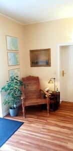 a living room with a bench and a potted plant at Hotel Seeburg in Sankt Peter-Ording