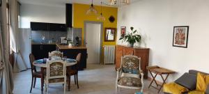 a kitchen and living room with a table and chairs at Rêve de Charme in Montrichard