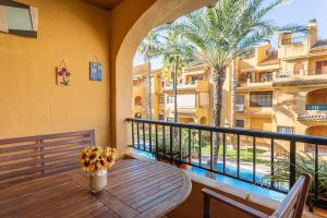 a balcony with a table and a view of a building at IDEAL para VERANO con PISCINA e INVIERNO con COCINA de LEÑA in La Mata