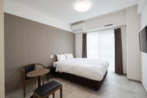 Posteľ alebo postele v izbe v ubytovaní BiBi Hotel 波之上