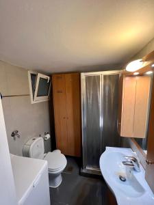 a small bathroom with a toilet and a sink at Loutraki Sunset Apartment in Loutraki +11 photos