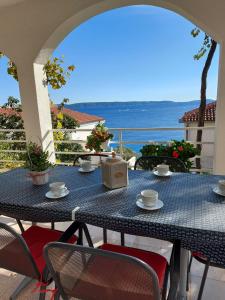 a blue table and chairs on a patio with the ocean at Apartment Nataša- Apt.1 in Trogir