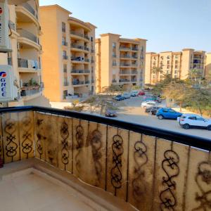 a balcony with a view of a parking lot at Afnan Guest- Rehab City in Burg el-Ḥudûd