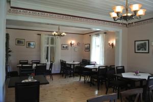 a restaurant with tables and chairs in a room at Eide gard in Skjolden