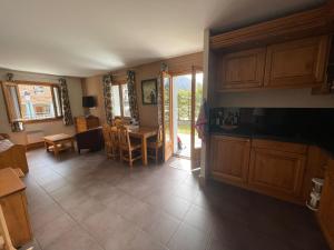 a living room with a kitchen and a dining room at Garden apartment SPA&Pool in Vallorcine