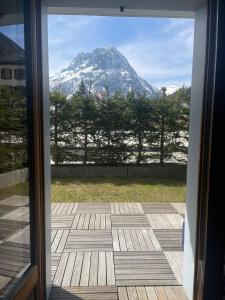 a view of a mountain from a sliding glass door at Garden apartment SPA&Pool in Vallorcine