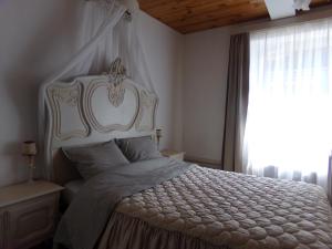 a bedroom with a white bed and a window at Chez Len & Filipp in Bouillon +29 photos