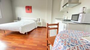 En eller flere senger på et rom på Apartamentos Pantón Ribeira Sacra