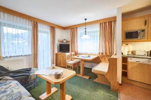 a room with a kitchen and a living room at Haus Sonnenweg in Leutasch