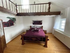 a bedroom with a bed and a wooden floor at Villa Maaremonte in Üdersdorf