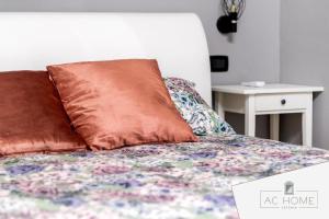 a bed with two pillows on top of it at AC HOME in Catania