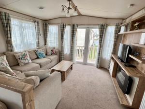 a living room with a couch and a tv at Butterfly Retreat - Dog Friendly in South Cerney