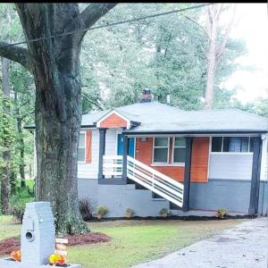 a house with a tree in front of it at Spacious Atlanta 2Bedroom/ 2Full Baths Renovated in Atlanta