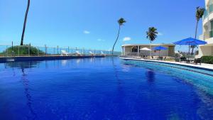 a large pool of blue water next to a building at Areias do Mar ! 2 Quartos, VistaMar + Varanda A205 in Barra de São Miguel