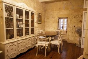 a dining room with a table and chairs at Town house steeped in history in Rabat