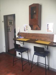 a bar with two chairs and a counter and two stools at LA BARRIERA UNO in Florence