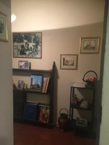 a living room with a book shelf and pictures on the wall at LA BARRIERA UNO in Florence