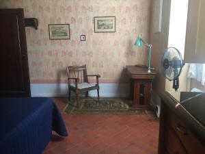 a bedroom with a chair and a desk and a lamp at LA BARRIERA UNO in Florence