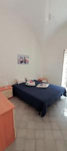 - une chambre dotée d'un lit bleu avec deux assiettes dans l'établissement Gabry & Dodò Hause, à Atrani