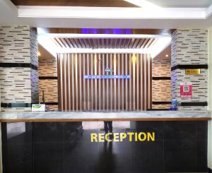 a counter in a store with a sign that reads reception at Hotel Cox's Hilton in Cox's Bazar