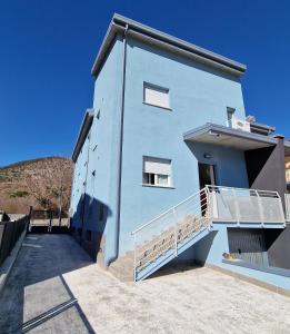 a blue building with a staircase on the side of it at La casa azzurra in LʼAquila