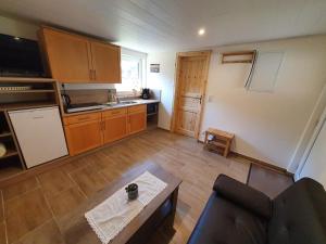 a living room with a couch and a kitchen at Ferienhaus Helmig in Kurort Gohrisch