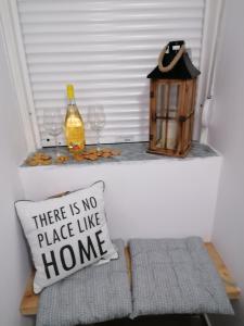 a pillow on a window sill with a no place like home at Crystal Blue Apartments in Nea Kalikratia